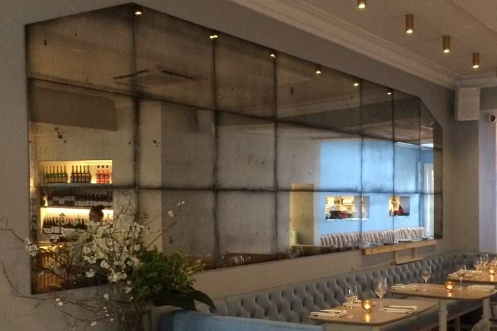 Restaurant With Antiqued Mirror Wall Regarding Antiqued Wall Mirrors (View 10 of 20)