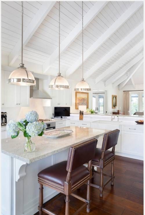 Three White Half Ball Pendant Lights Hang From A Tall Vaulted With Vaulted Ceiling Pendant Lighting (View 2 of 15)