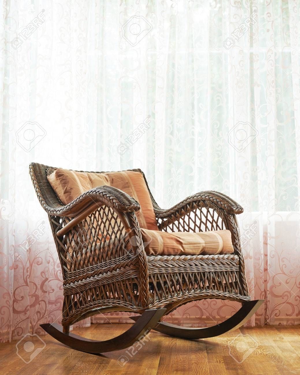 Brown Wicker Rocking Chair Against The Window's Curtains, Indoor Regarding Indoor Wicker Rocking Chairs (View 3 of 15)
