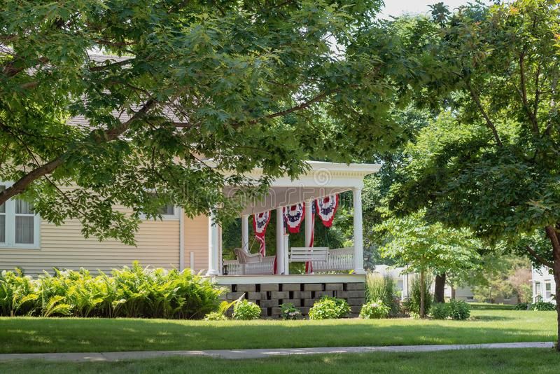 Charming Front Porch Decorated With American Flags For Regarding American Flag Porch Swings (View 15 of 20)