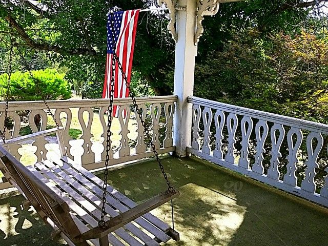 Old House Porch Swing Stock Photo 27e73a60 6a24 4a8a In American Flag Porch Swings (View 13 of 20)