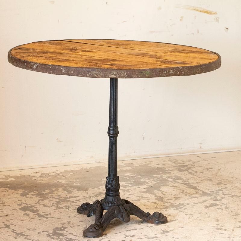 Vintage Round Bistro Table With Black Cast Iron Base Pertaining To Oval Aged Black Iron Console Tables (View 18 of 20)