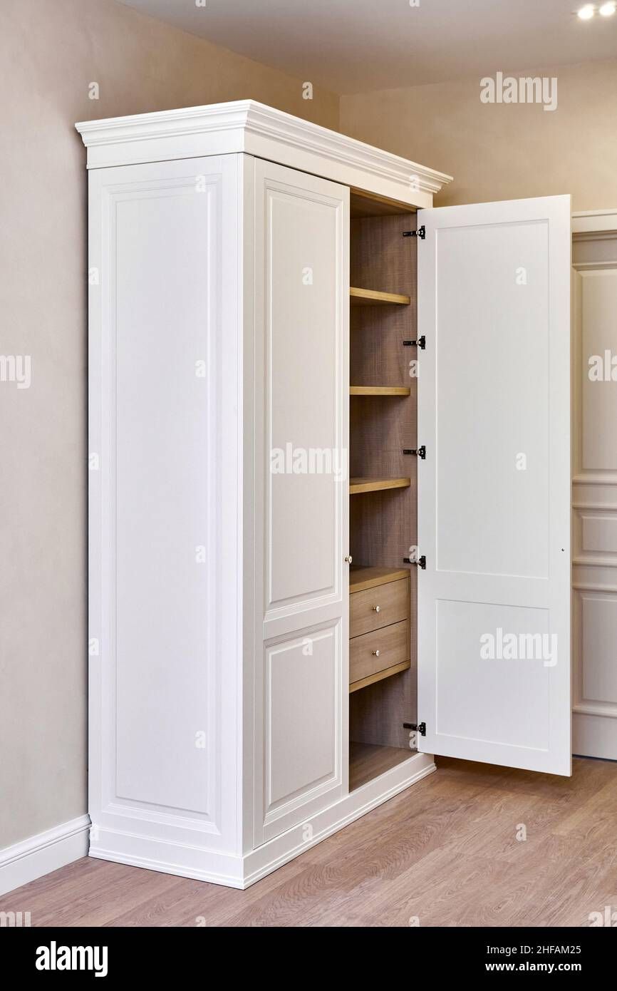 White Vintage Wardrobe With Crown Moldings Wooden Shelves And Drawers And  Open Facade Door In Light Empty Room In Luxury Apartment Stock Photo – Alamy Intended For White Vintage Wardrobes (View 8 of 15)